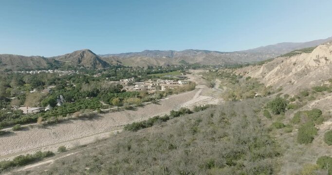 aerial view of badlands desert valley with dry terrain