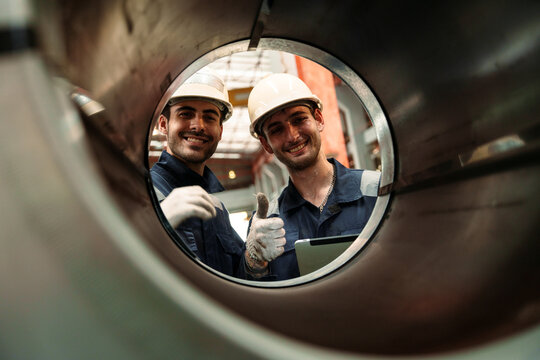 Engineers and staff are inspecting the assembly line system in a metal sheet and metal roofing manufacturing plant.