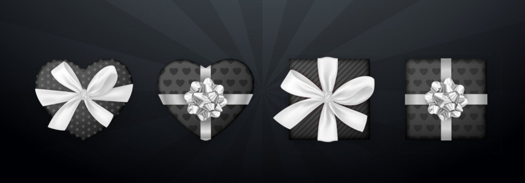 Top view 3d gift boxes set with white ribbon bow isolated on a black background