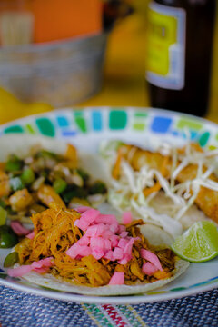 Authentic Mexican Cochinita Pibil Tacos with Pickled Red Onions on a Traditional Ceramic Plate