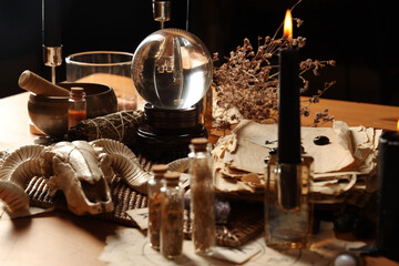 Crystal ball and magic attributes on table © Pixel-Shot