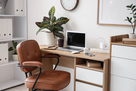 Workplace with gadgets and charger in office