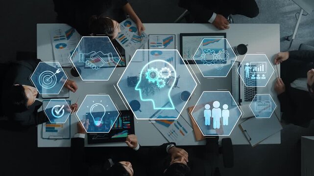 An overhead view of a collaborative business meeting showcasing professionals discussing market trends with digital visualizations highlighting innovative ideas and insights. Raster