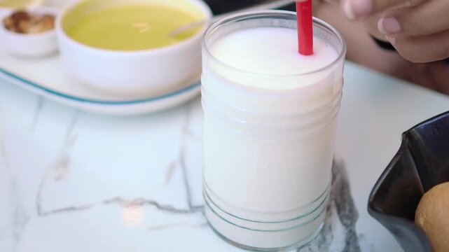 turkish traditional drink ayran in glass of a table .
