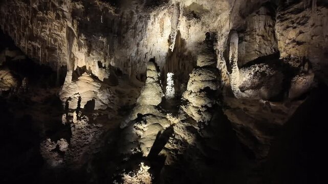 Illuminated stalactites and stalagmites in a cave.