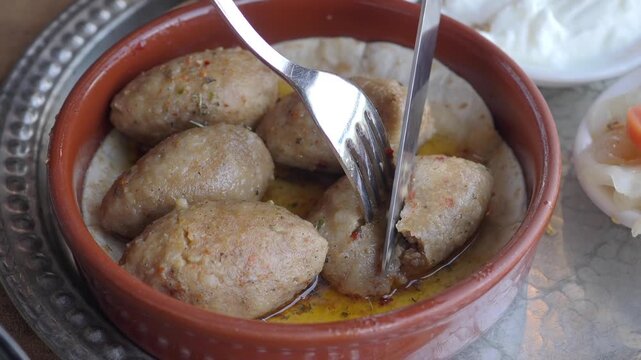 Cutting and Eating Traditional Kibbeh in a Restaurant