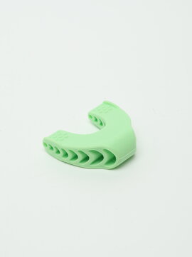 Light green silicone jawline exerciser and jaw trainer isolated on white background