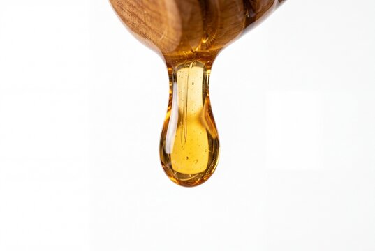 Macro Closeup of Fresh Golden Honey Dripping from Wooden Dipper