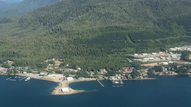 Aerial tracking view of ketchikan coastline and temperate rainforest.