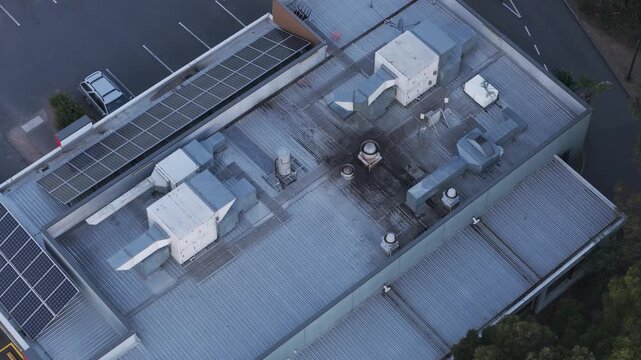 Aerial view of industrial building roof fire with thick black smoke
