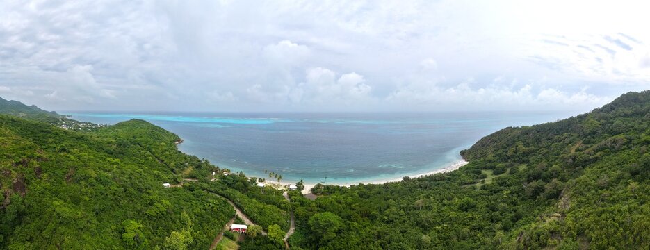 Panoramic Aerial View of Manchineel Bay Manzanillo Beach Surrounded by Lush Green Tropical Hills and Turquoise Sea in Providencia Island, Colombia Caribbean Travel Destination Background