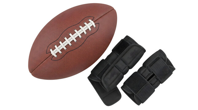 American football ball and black wrist support braces isolated on a solid black background for sports equipment concepts