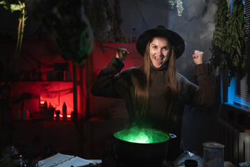 Happy realistic witch brewing a potion in cauldron celebrating win and victory. Blend of everyday life with traditional witchcraft, magic and mystical atmosphere © Andrii Lysenko