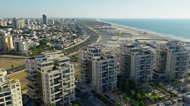 Aerial drone shot of luxury residential buildings and penthouses located in Ashdod Israel with the Mediterranean Sea and coastline in the background.
