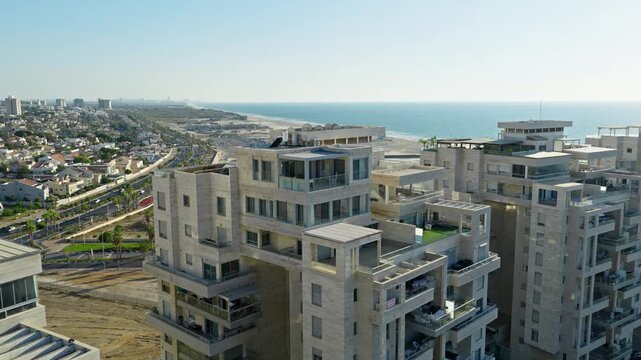 Aerial drone view over modern luxury residential buildings and penthouses near Ashdod Marina with the Mediterranean Sea and beach shoreline in the background Israel.