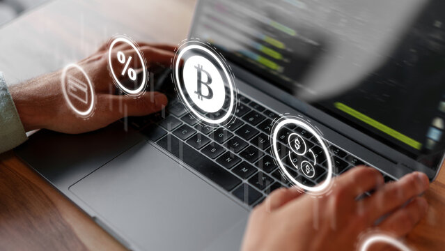 Digital currency trading on a laptop with cryptocurrency symbols in the foreground