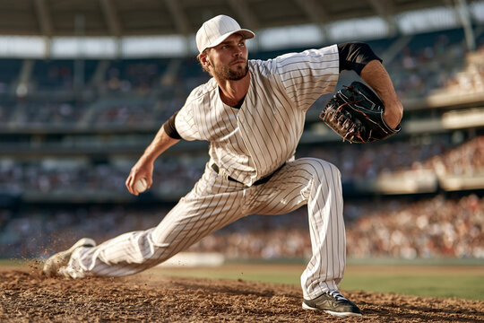Athlete pitches with focused intensity. Dirt flies as he releases the ball. Fans fill the stadium behind him. His stance shows power and precision. Perfect for sports or athletic campaigns