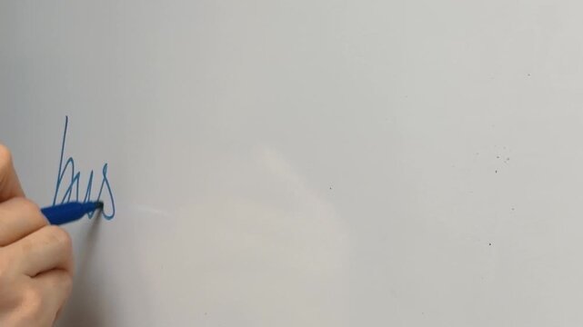 Hand Writing Business Plan on a Whiteboard with a Blue Marker