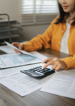 The concept of tax return preparation and financial management. Businessman calculates taxes. finance, Income tax, tax documents, and savings. Portrait-oriented image.