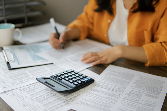 The concept of tax return preparation and financial management. Businessman calculates taxes. finance, Income tax, tax documents, and savings.