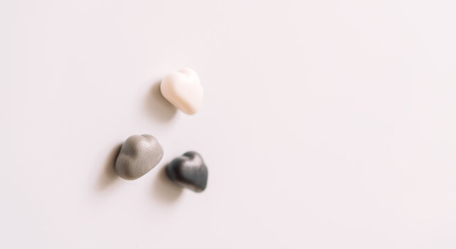 Three cloud-shaped whiteboard magnets viewed at an angle with selective focus.