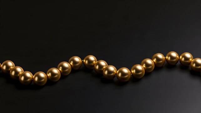 Golden baubles in a wave pattern on matte black surface