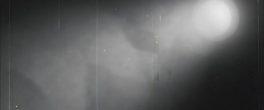 Abstract grayscale background with soft light diffusion and dust particles