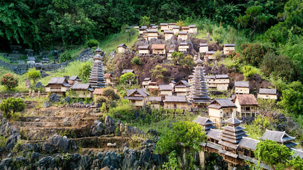 Traditional Chinese ethnic village miniature replica with wooden stilt houses, stone terraces, and ancient pagodas  at Splendid China Folk Village theme park in Shenzhen, Guangdong, China © runny1975