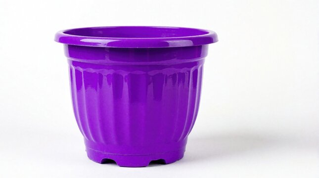 Bright purple plastic pot sits empty on white background. Container shows ribbed sides and open top rim. Simple object for gardening or design studio use.
