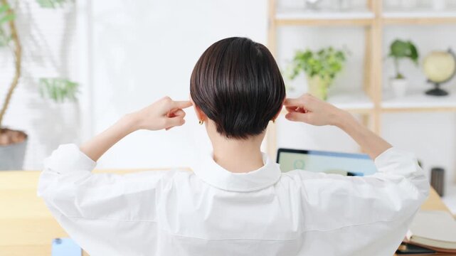 The back view of a woman troubled in her room. Work, household budget, anxiety, worry, dissatisfaction, doubts, thinking, trouble, problems, stress, fatigue