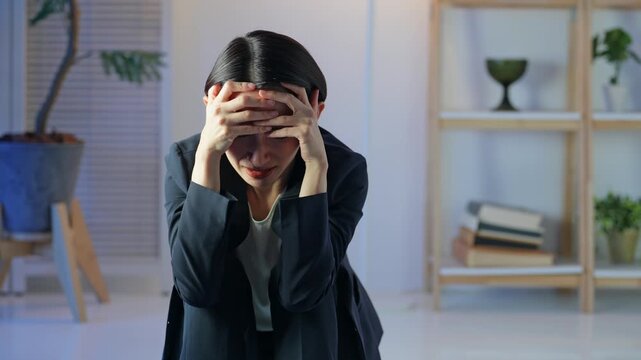 A middle-aged woman is depressed in a dark room. Worries, anxieties, worries, stress, depression, despair, mental health, regret, failure