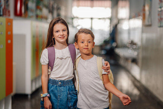 School children friends standing in hallway