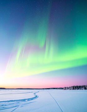 Vibrant Aurora Borealis Over Snow-Covered Landscape at Dusk