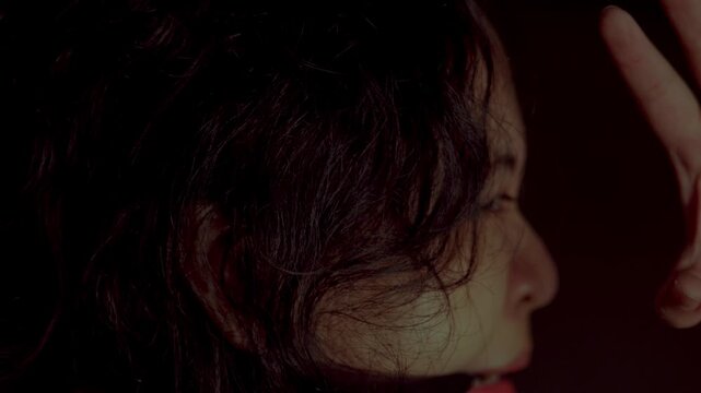 Cinematic side profile of a terrified gagged woman trying to escape. Her eyes show intense panic and desperation in a moody low-light environment representing kidnapping or abuse.