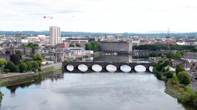Historical bridge in Limerick city. Drone view with John's Castle and riverfront. Ireland cityscape
