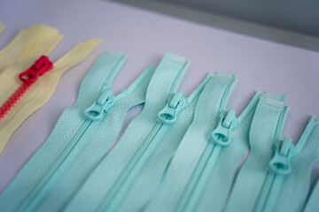 Various colored nylon zippers laid out neatly on a flat surface © Zhaorui