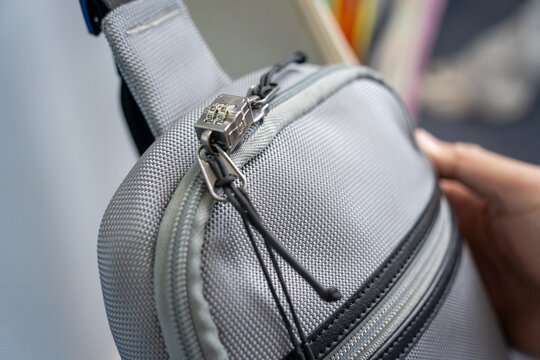 Close up of lock secured zipper on gray textured bag