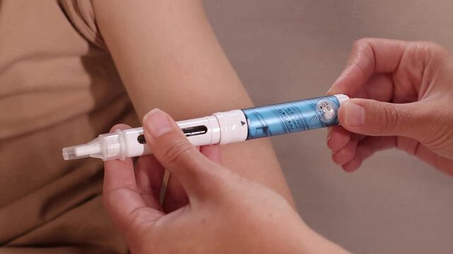 Injection pen positioned near childs upper arm