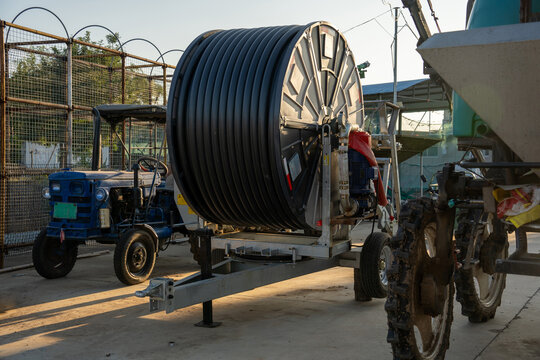 Agricultural equipment with large hose reel and small tractor