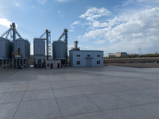 Industrial silos and factory building under blue sky with white clouds © zhu difeng