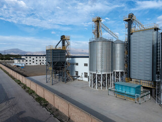 Industrial silo facilities under blue sky and white clouds © zhu difeng