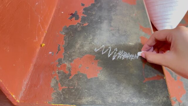 Video of drawing abstract chalk scribbles on a surface.