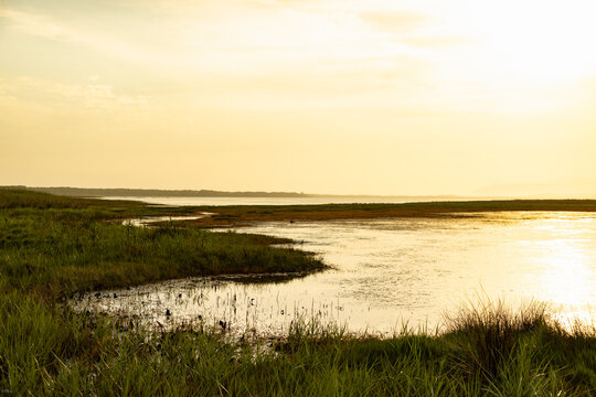 pastel sunset over placid lagoon and Klein Mountain reflection, Stanford, South Africa