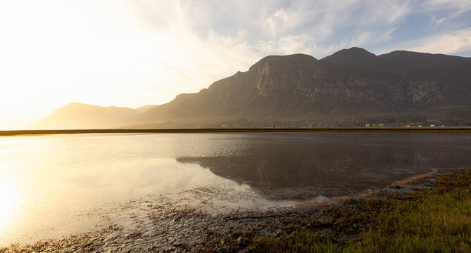 pastel sunset over placid lagoon and Klein Mountain reflection, Stanford, South Africa