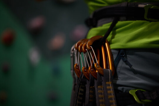 Close up of boulderer with harness and professional safety equipment.