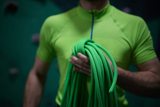 Close up of rock climber holding rope before bouldering practice.