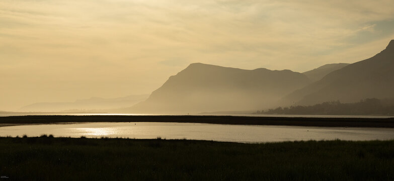 pastel sunset over placid lagoon and Klein Mountain reflection, Stanford, South Africa
