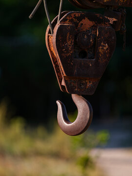 Old rusty metal hook on heavy construction machinery