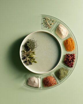 Curated spices rest beside a textured ceramic plate