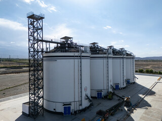 Large white cylindrical grain silos for agricultural storage facility © zhu difeng